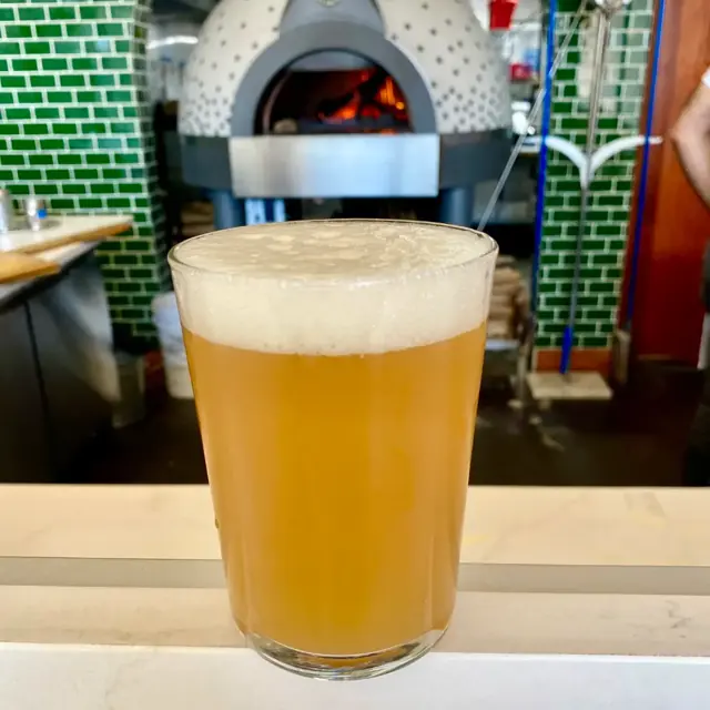 A craft beer in front of the oven