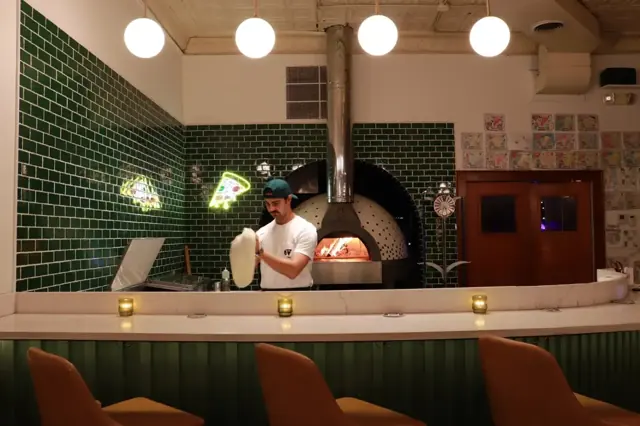 Stretching dough by the oven